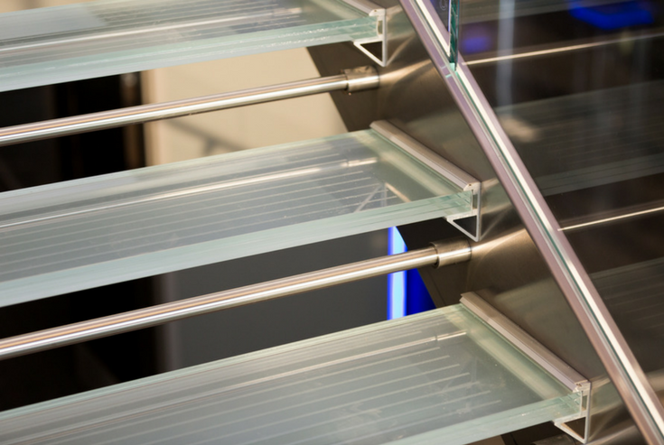 Close up of a glass stair tread bracket aluminum support system | Innovate Building Solutions