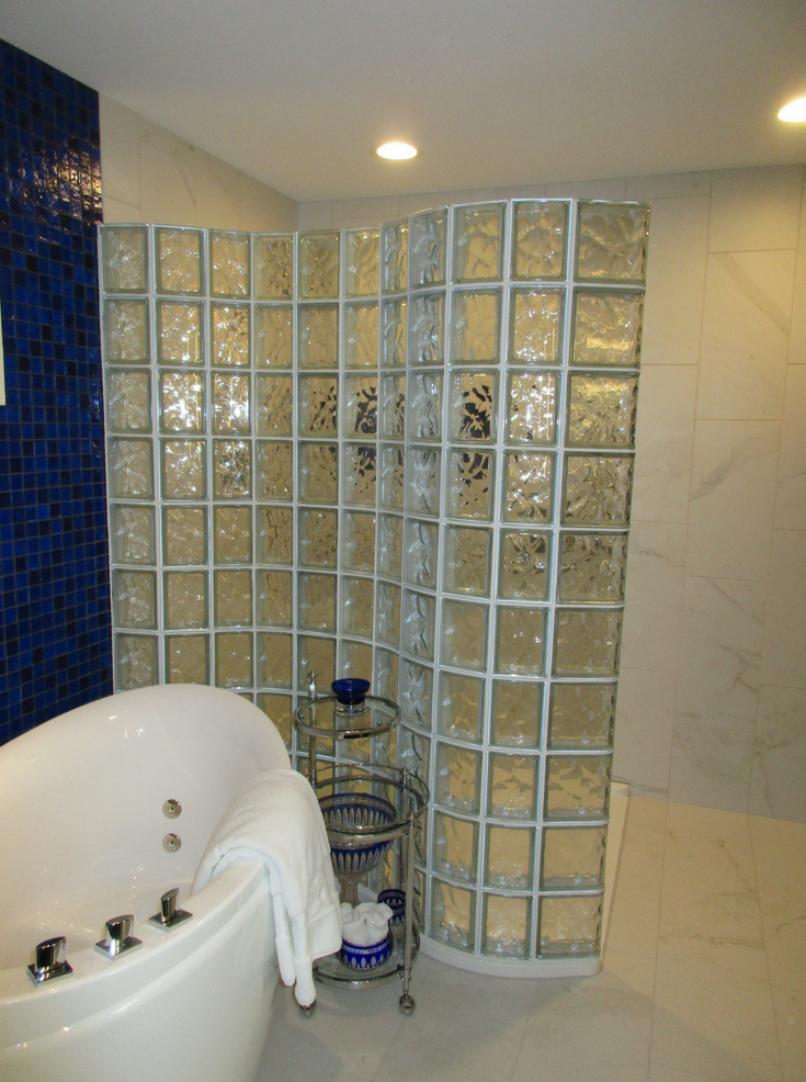 Glass Block Wall That Snakes Around Tub | Innovate Building Solutions | #GlassBlockWall #GlassBlockDesign #CondoLiving