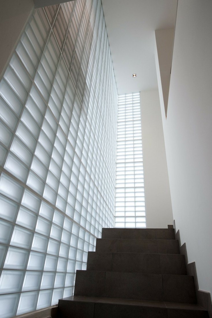 Frosted glass block stairwell in a modern home- Innovate Building Solutions