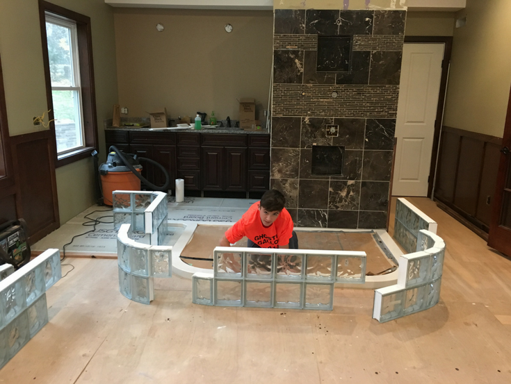 Glass block wall sections staged to go on a cultured stone base | Innovate Building Solutions | #GlassBlockWall #GlassBlockDesign #ColorGlassBlock