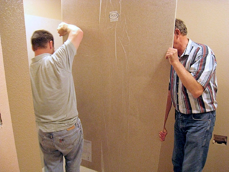 Installing solid surface shower panels | Innovate Building Solutions | #SolidSurface #ShowerRemodel #ClevelandRemodel