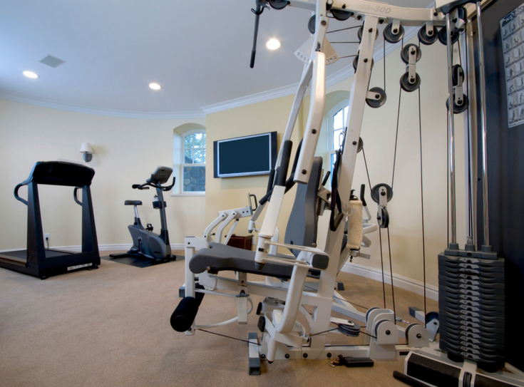 Create private spaces in basement exercise room | Innovate Building Solutions | #BasementExerciseRoom #BasementRemodel #GlassBlockWindows