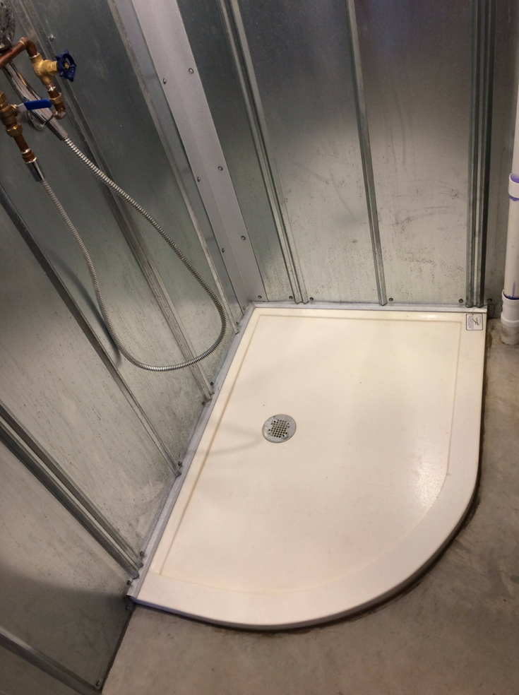 Custom drain location solid surface shower pan | Innovate Building Solutions | #SolidSurfaceBase #CustomShowerBase #ShowerRemodel
