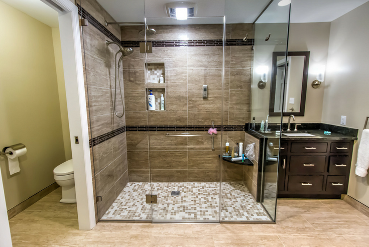 Glass enclosure with a flat floor barrier free shower system | Innovate Building Solutions | #ShowerSystem #BathroomRemodeling #TiledShowerBase