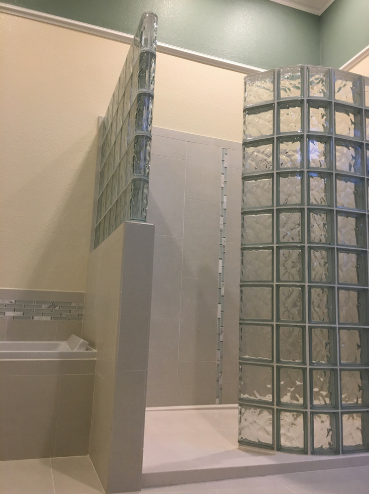 Glass block walk in shower with a curved wall | Innovate Building Solutions | #GlassBlockShower #ShowerWall #WalkInShower