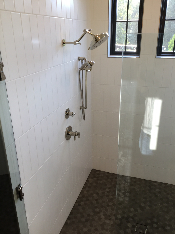 Black trimmed transom windows in a Columbus shower 3 Pillar Homes | Innovate Building Solutions | #BathroomDesign #ShowerWinodw #BathroomTrends