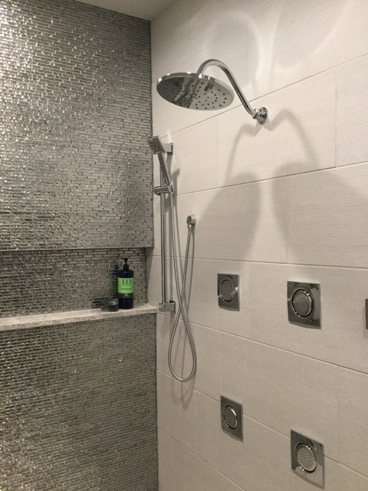 Hand held shower in a luxury bathroom | Innovate Building Solutions | #BathroomShower #LuxuryBathroom #WetRoom