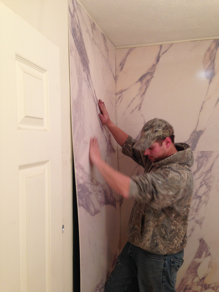 Installing faux granite wall panels | Innovate Building Solutions | #FauxGrante #DIYShowerPanels #InstallingPanels