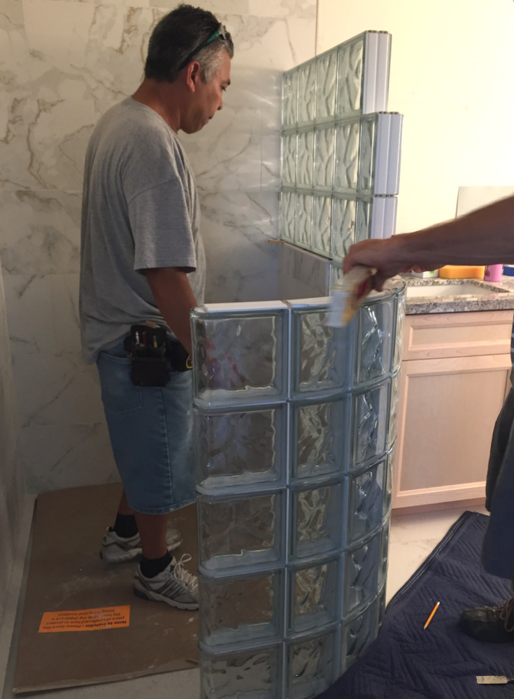 Installing a glass block curved wall in bathroom remodel | Innovate Building Solutions #GlassBlockInstall #GlassBlockWall #GlassBlockShower #ShowerBase