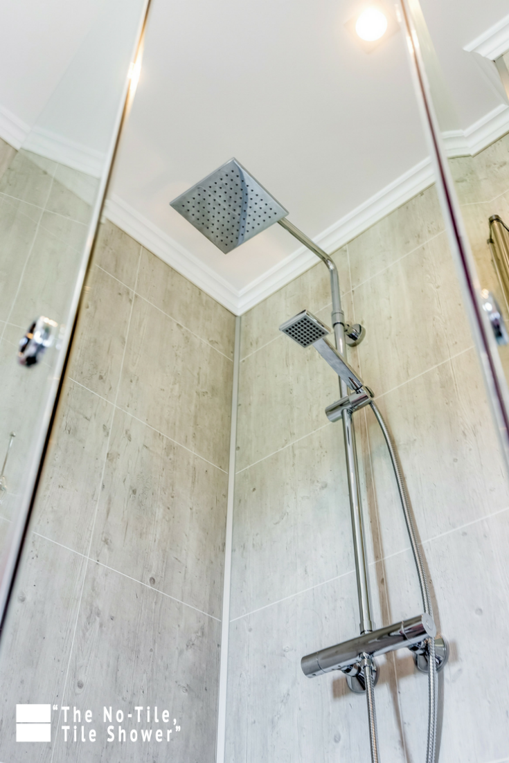 Decorative laminated wall panels in a custom shower | Innovate Building Solutions | #CustomShower #LaminatePanels #BathroomRemodeling