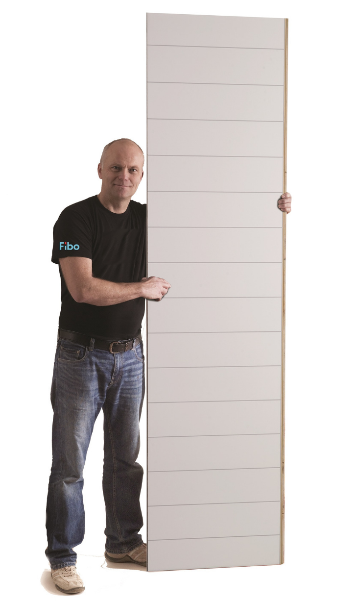 Guy holding up 2 foot by 8 foot laminated wall panel | Innovate Building Solutions | #LaminatePanels #ShowerWallPanels #DIYShowerPanels