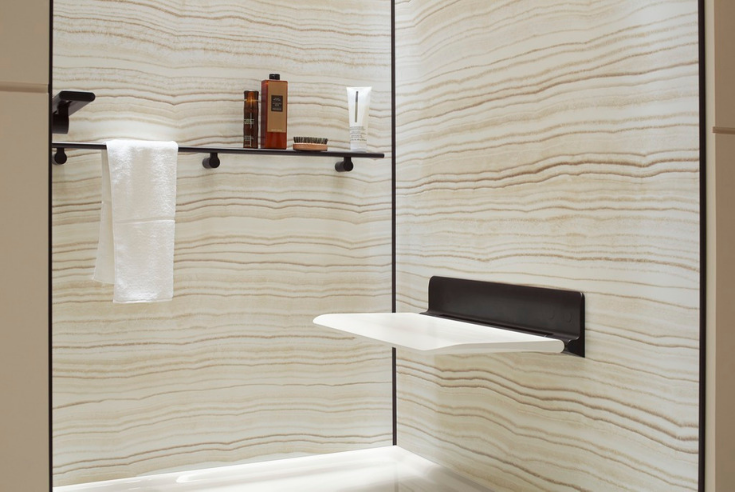 Fold down seat in a minimalist bath design | Innovate Building Solutions | #FoldedSeat #BathroomRemodeling #ShowerRemodeling
