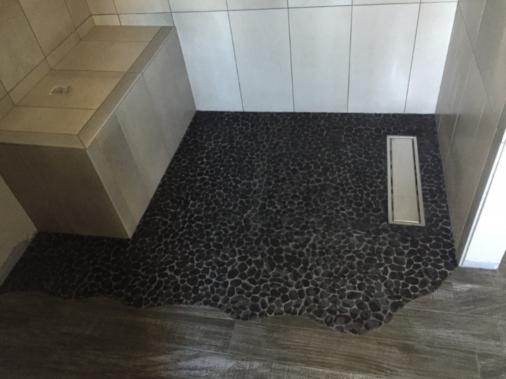 Llinear shower drain in a wet room shower | Innovate Building Solutions | #ShowerDrain #RollInShower #OneLevelWetRoom #WetRoom