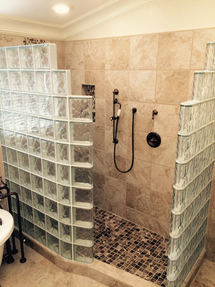 Curved glass block shower wall with a ready for tile shower pan | Innovate Building Solutions | #GlassBlockShower #CurvedGlassBlock #GlassBlockShowerDesign #ShowerBase #TiledBase