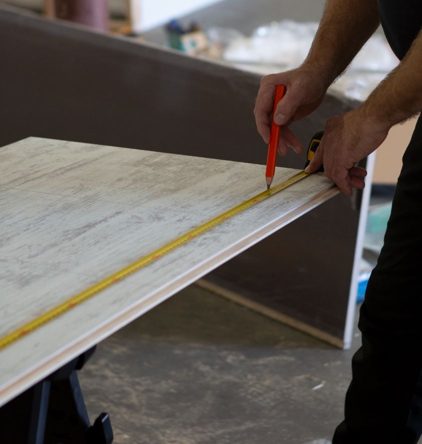 2 foot by 8 foot laminated wall panels being marked for cutting | Innovate Building Solutions | #LaminatePanels #CuttingPanels #HowToCutPanels #ShowerWallPanels