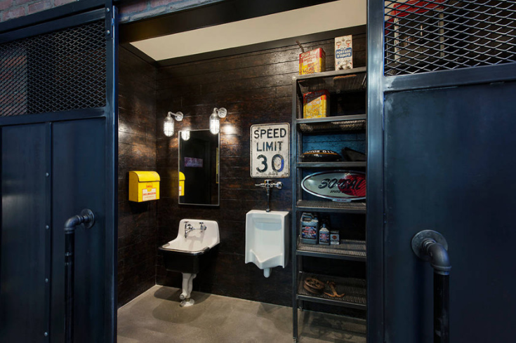 Fun quirky signs in an industrial chic bathroom design | Innovate Building Solutions | #IndustrialBathroom #Funkybathroom #BathroomDesign