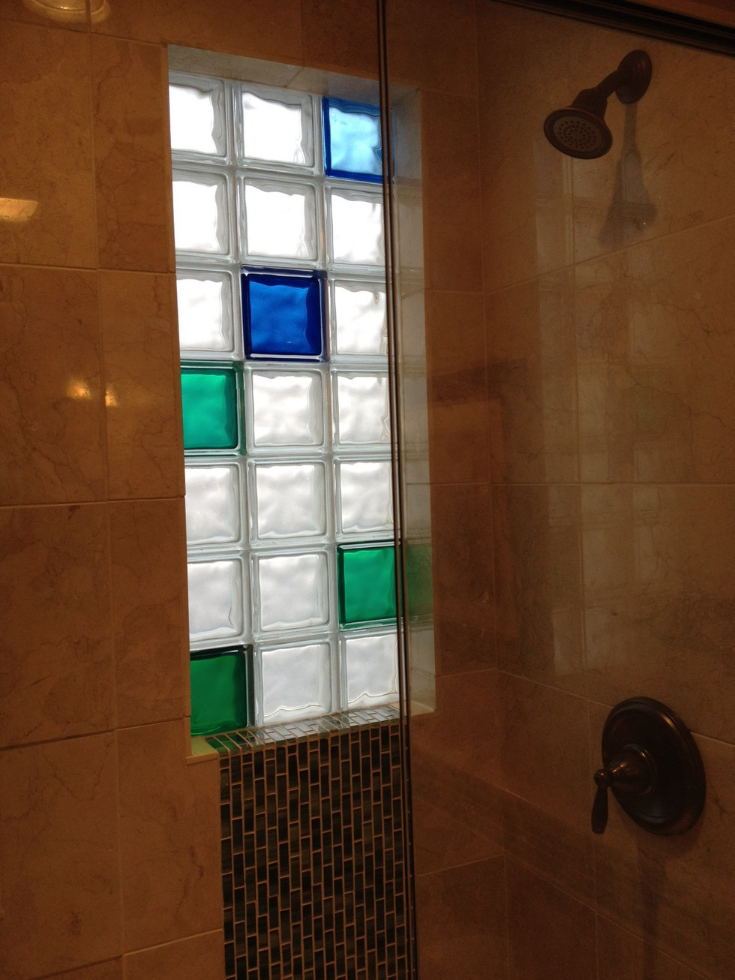 Blue and green colored glass block shower window | Innovate Building Solutions | #ColoredGlassBlock #GlassBlockWindow #BathroomWindow