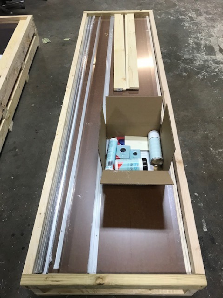 Laminate wall panels a crate ready for shipment with accessories | Innovate Building Solutions | #laminatePanels #BathroomWallPanels #ShippingWallPanels