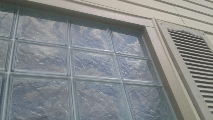 glass block window finished with coil stock on outside | Innovate Building Solutions | #GlassBlockWindow #Outsidetrim #GlassBlockBathroom