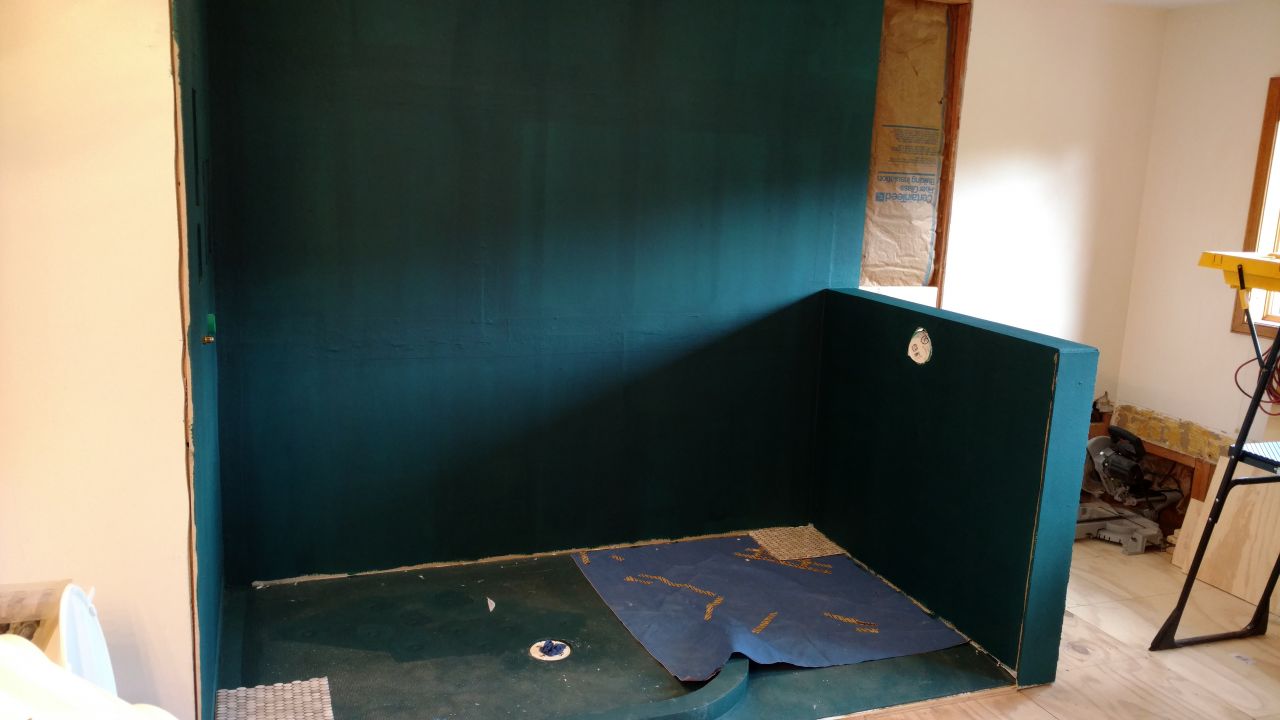 Red guard over cement backer board in a bath remodel | Innovate Building Solutions | #Backerboard #WaterproofSystem #ShowerwallSystem #bathroomRemodel