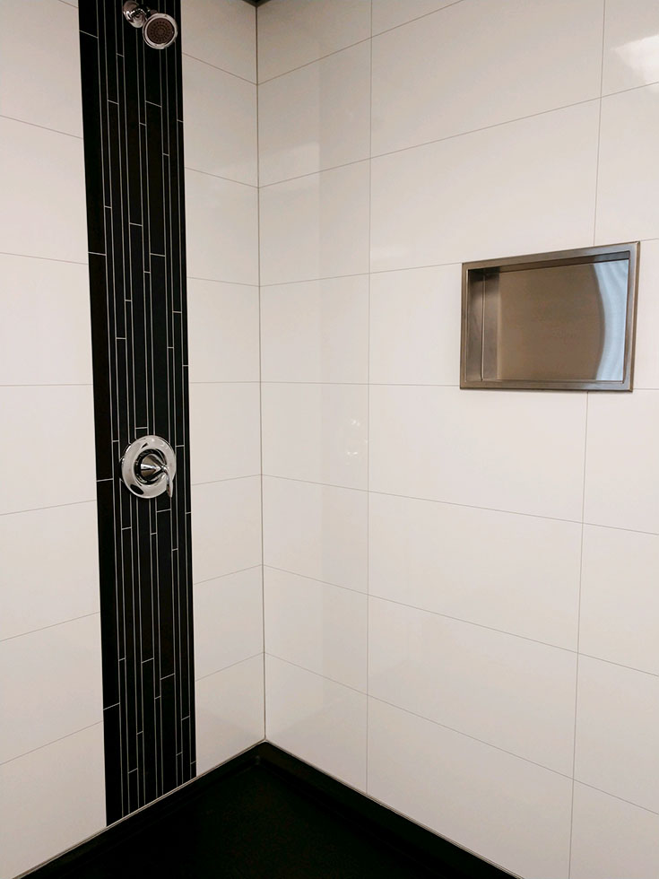 Preformed brushed stainless shower niche | Innovate Building Solutions | #ShowerNiches #StainlessShowerNiche #ShowerRemodel #ShampooHolder