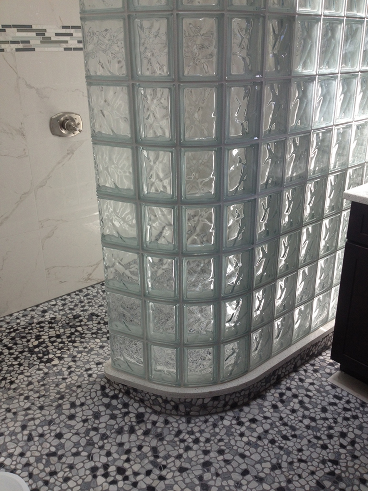 Curved glass block shower wall ready for tile base | Innovate Building Solutions | #GlassBlockShower #Readyfortile #Tilebase #WalkInshower