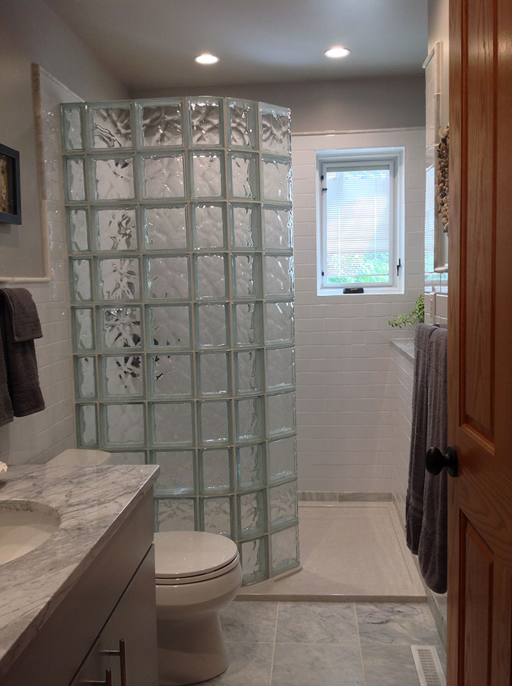 Curved glass block shower and a high gloss cultured granite shower base | Innovate Building Solutions | #GlassBlockWall #GlassBlockDesign #ShowerWall