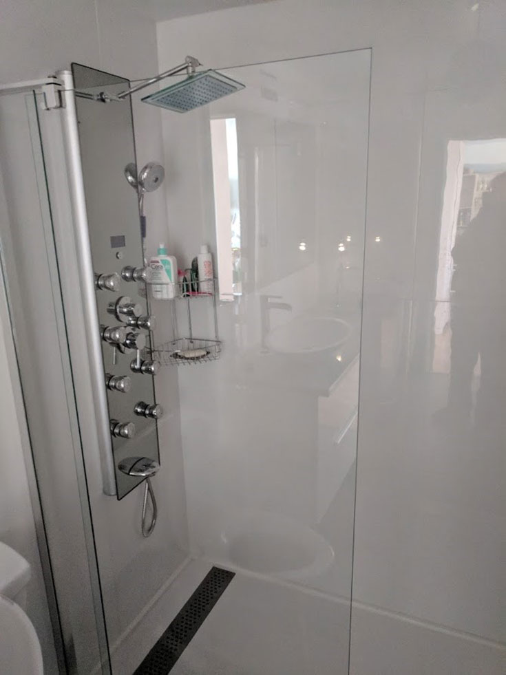 white cultured granite shower pan linear drain | Innovate Building Solutions | #culturedGranite #ShowerPan #HighGlosspanels