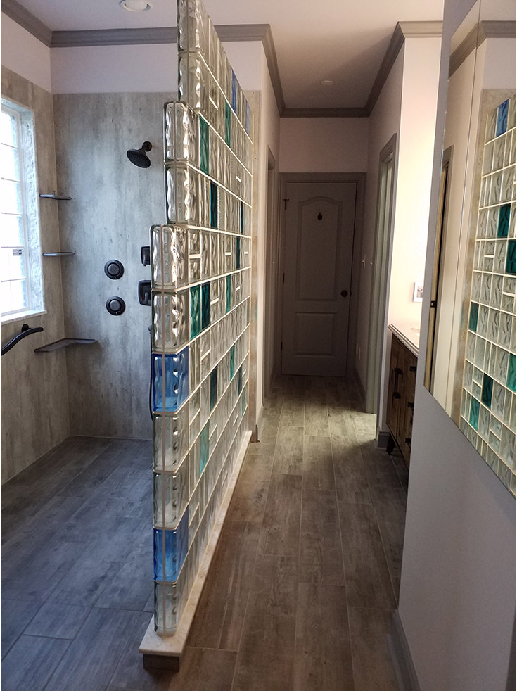 Cracked cement simple to install laminate shower panels in a roll in shower | Innovate Building Solutions | #GlassBlockShower #WalkInShower #ColorGlassBlock