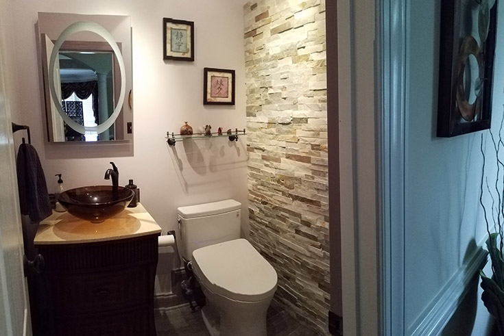 Toto toilet and stone wall in a water closet in North Carolina remodel | Innovate Building Solutions | #ToToToilet #StoneWall #BathroomRemodel