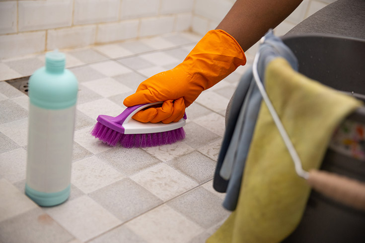 cleaning tile grout joints on a shower pan floor | Innovate Building Solutions | #cleaninggrout #TileShower #ShowerPan #GroutJoints