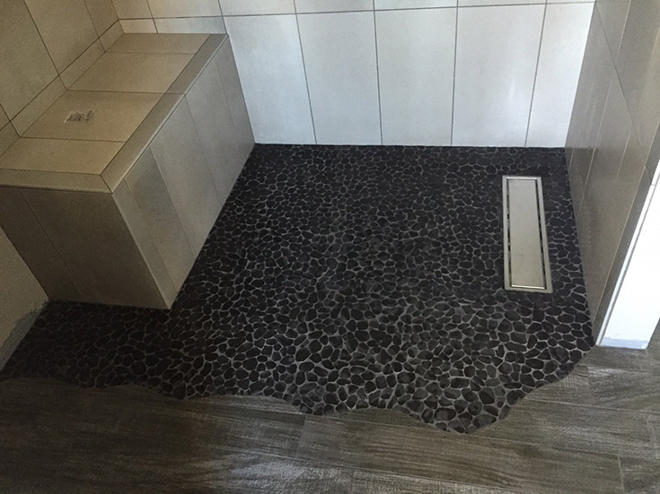 creative tile shower floor and a one level design | Innovate Building Solutions | #CreativeTIleShower #TileShower #OneLevelWetRoom