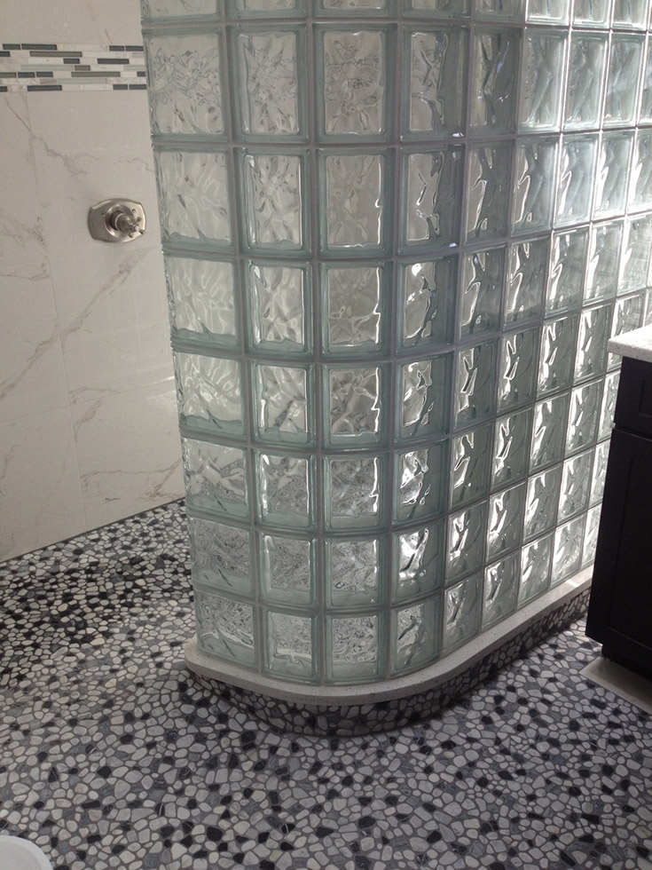 glass block wall with a mosaic tile shower pan floor which is hard to maintain | Innovate Building Solutions | #GlassBlockShower #TileShower #GlasaBlockShower