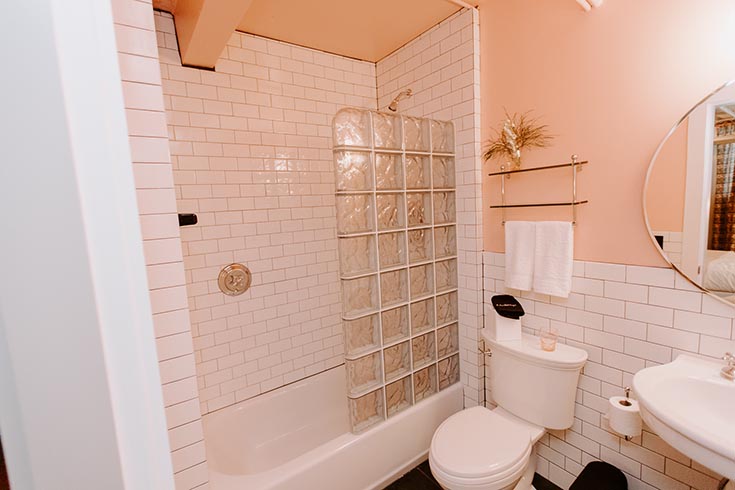 Fun Bonnie and Clyde room art deco glass block shower and subway tile | Innovate Building Solutions | #Glassblock #Shower #BathroomRemodel