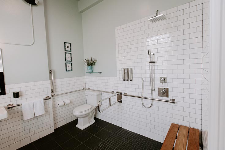 Functional ADA shower wtih subway tile in The Bank East Aurora New York | #ADAShower #RollinShower #AirBNB 