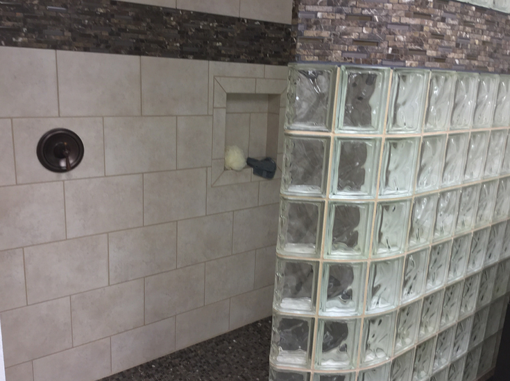 Shower valve by opening in a walk in glass block curved shower | Innovate Building Solutions | #Glassblockshower #GlassShowerwall #WalkInShower