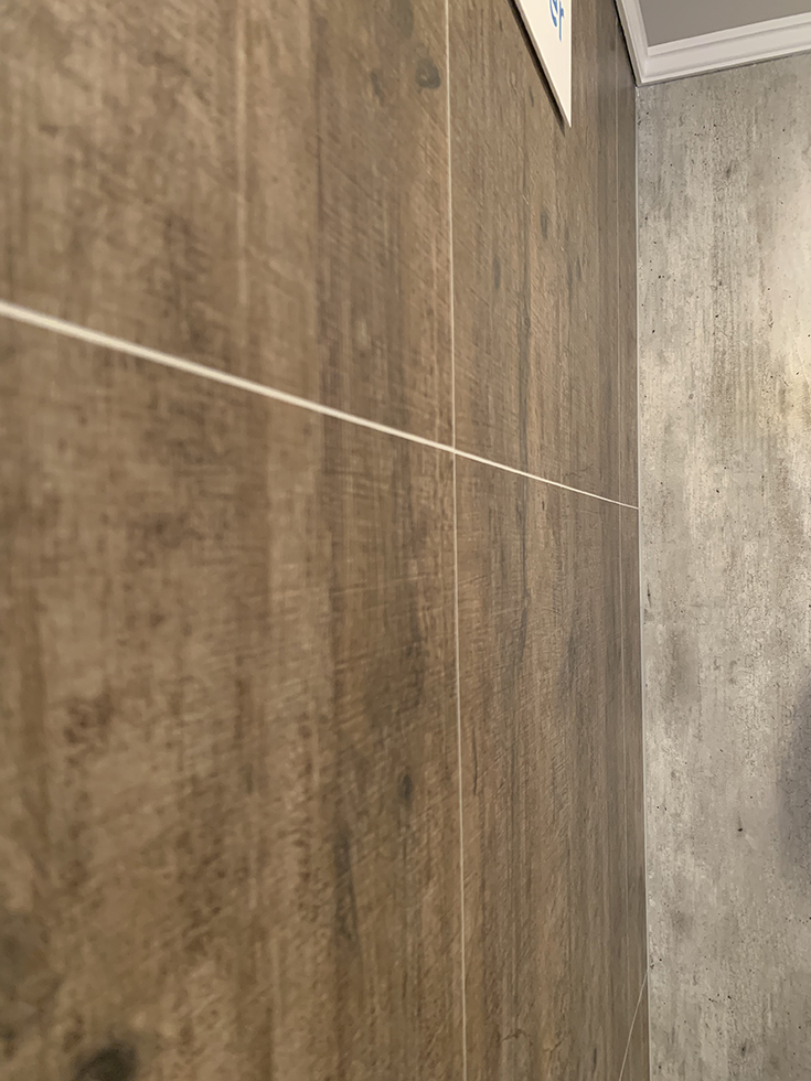 rough wood and cracked cement organic laminate shower wall panels | Innovate Building Solutions | #CrackedCement #WallPanels #LaminateShower