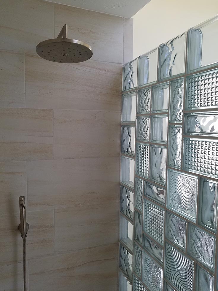 stained glass look in a glass block multi size pattern wall | Innovate Building Solutions | #GlassBlock #GlassBlockWall #ShowerWall