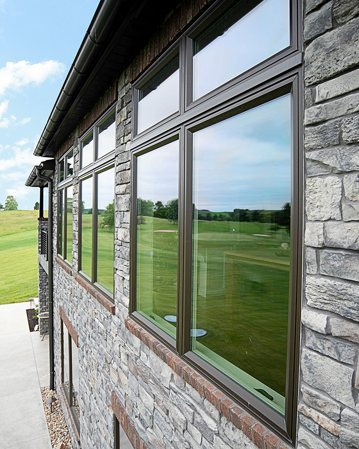 Pro 4 brown casement windows in a stone veneer home cleveland ohio | Innovate Building Solutions #VinylWindows #CasementWindows #BrownWindows