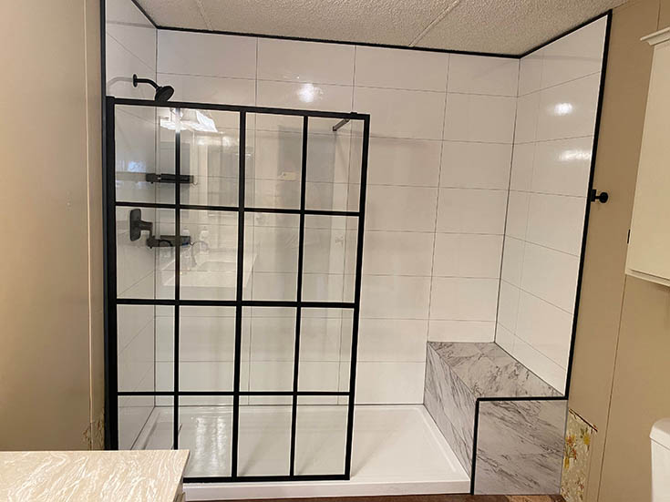 Quality 10 White Marble 24x24 - with matte black L Profiles | Innovate Building Solutions #Laminatewallpanels #Seating #ShowerSurround