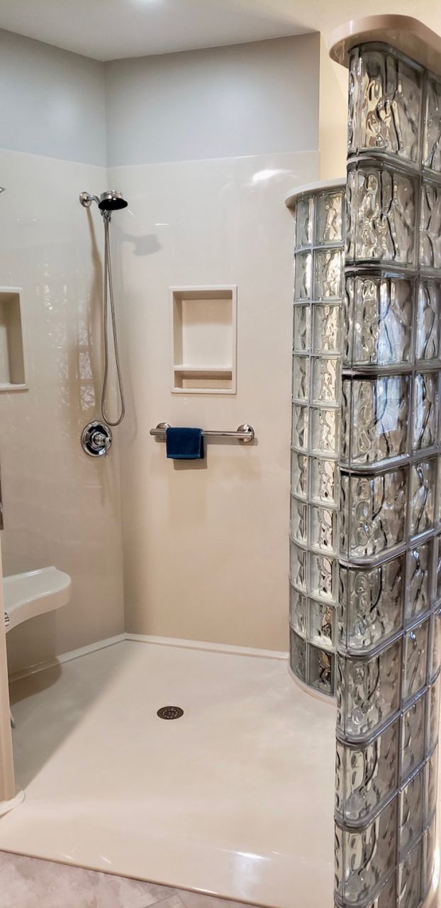 Section 1 definion ramped shower pan with solid surface base and glass block curved wall | Innovate Building Solutions #rampedshower #Showerbase #HandicapAccessible #rollinshower