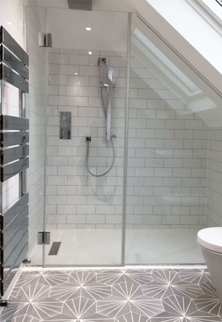 Reason 2 short - angled glass shower door under a stairwell | Innovate Building Solutions #GlassShowerdoor #Customglass #ShowerShowerDoor #BathroomRemodelCustomglass
