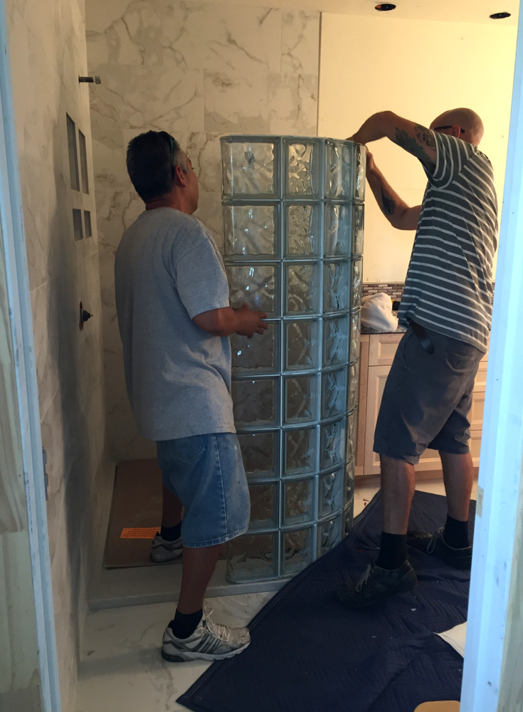 Factor 12 installation of preassembled curved glass shower shower sections | Innovate Building Solutions #GlassBlock #ShowerEnclosures #GlassBlockShowerEnclosures