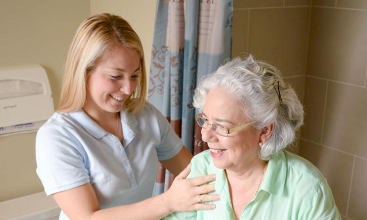 Tip 8 occupational therapist with older person in bathroom credit AdventHealth University | Innovate Building Solutions #AgeInPlaceBathroomRemodel #AgeInPlaceShowerRemodel #LaminateShowerWallPanels