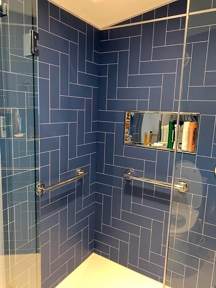 Problem 12 grab bars with glass doors blue herringbone wall panels | Innovate Building Solutions | Grab bars | Bathroom remodeling