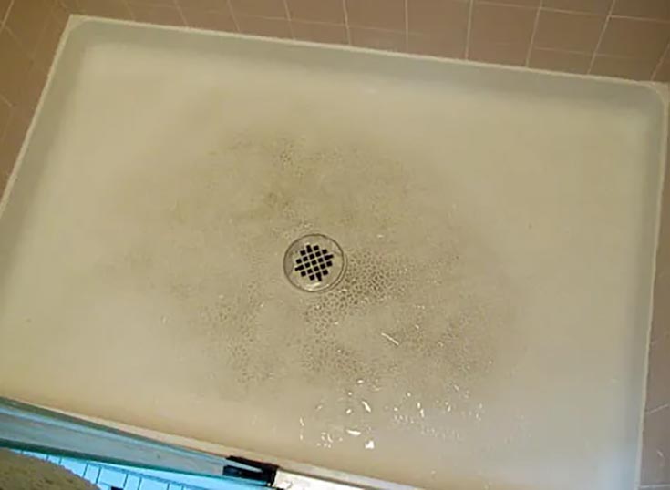 Idea 9 yellowed and dirty fiberglass shower pan credit Retro Renovation | Innovate Building Solutions | bathroom design ideas | yellow shower base 
