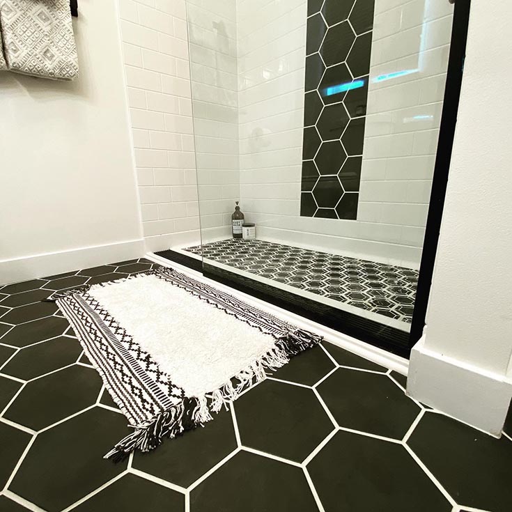 Ramped roll in shower with black linear drain | Innovate Building Solutions | Ramped Shower pan | Shower Design ideas for handicap accessible