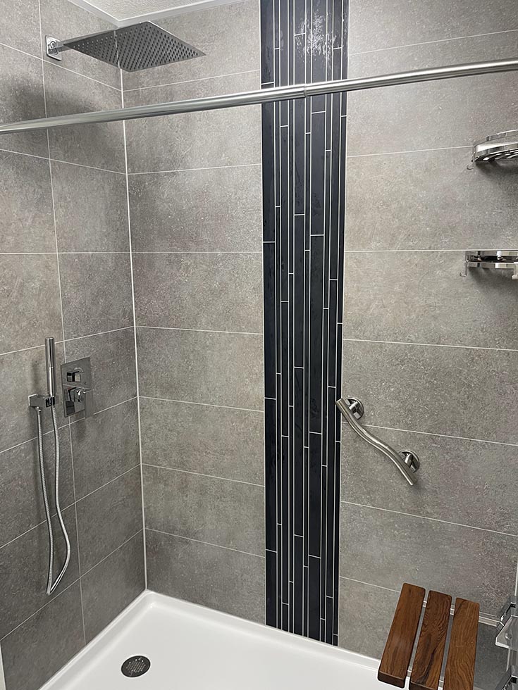 Fact 4 matte black vertical accent in shower wall panel system | Innovate Building Solutions | Cleveland Bathroom Remodeling | Bathroom TIps