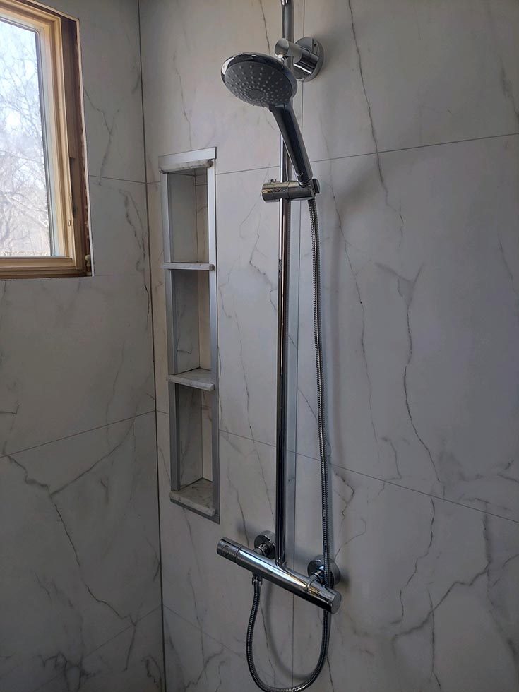 Fact 8 smaller shower Bianco marble wall panels and niche Details | Innovate Building Solutions | Shower Design ideas | bathroom remodeling tips | Bianco Marble for bathroom walls