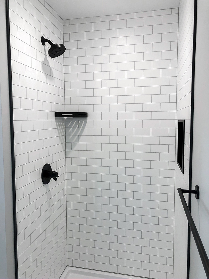 Step 2 laminate wall panels in a white subway tile design - Innovate Building Solutions, Cleveland Ohio Shower Designs, Shower Wall Panels, Custom DIY Bathroom Shower, Bathroom Remodeling Project